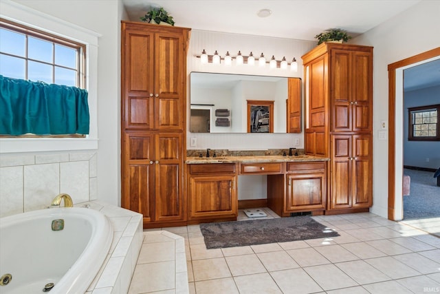 bathroom with vanity, a relaxing tiled tub, and tile patterned floors