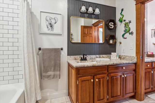 bathroom featuring tile patterned flooring, vanity, and shower / tub combo