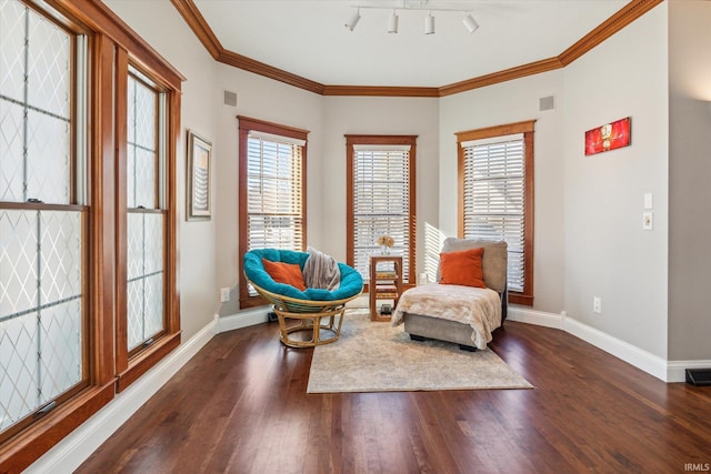 sitting room with crown molding, a healthy amount of sunlight, and dark hardwood / wood-style flooring