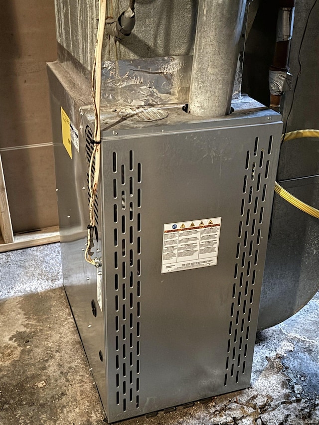 utility room featuring heating unit