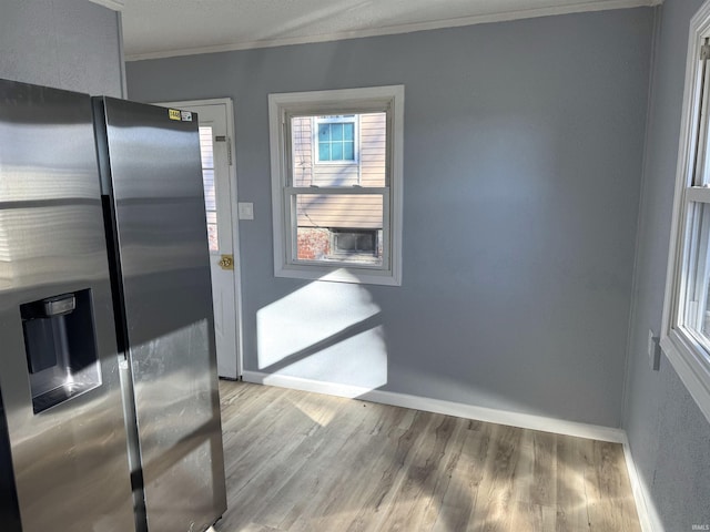 doorway to outside with ornamental molding and hardwood / wood-style floors