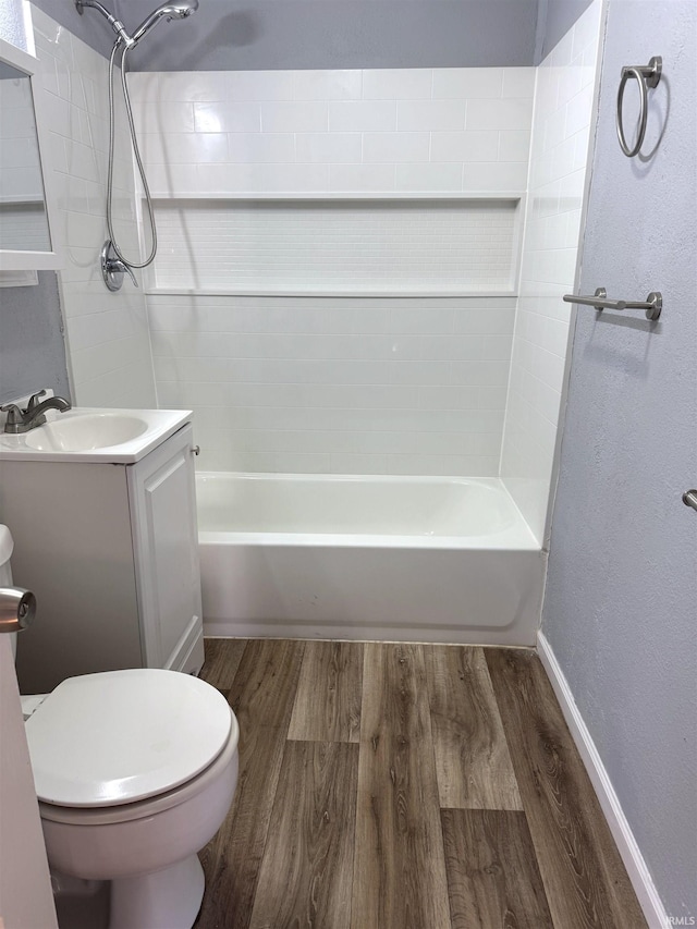 full bathroom with vanity, toilet, tiled shower / bath combo, and hardwood / wood-style floors