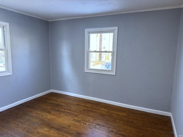 unfurnished room featuring dark hardwood / wood-style flooring and ornamental molding