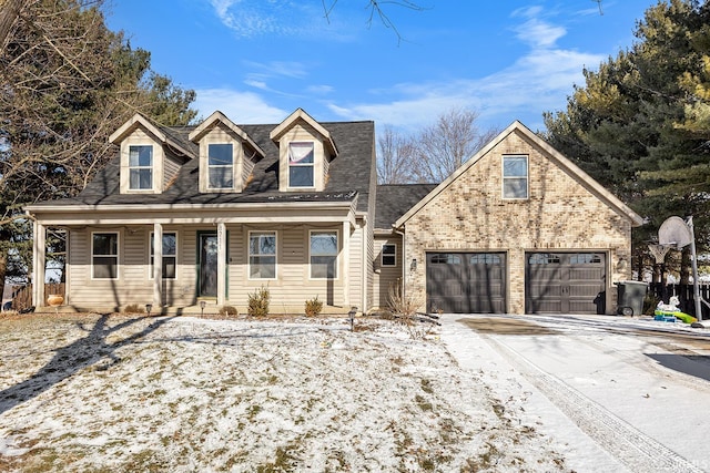 cape cod-style house with a garage and covered porch