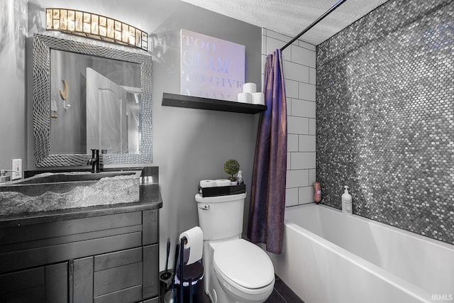 full bathroom with vanity, shower / bath combo, toilet, and a textured ceiling