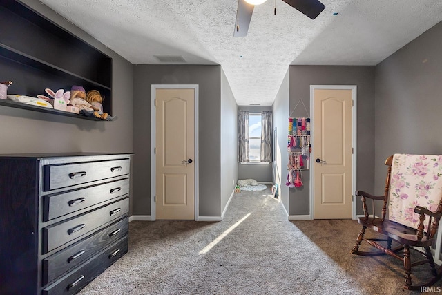 carpeted bedroom featuring a textured ceiling and ceiling fan