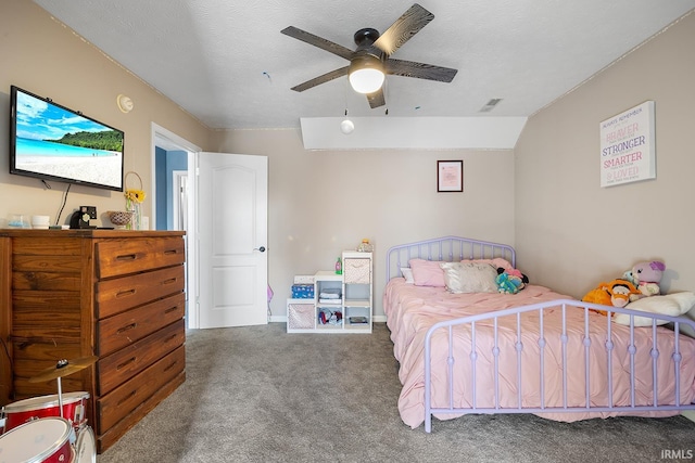 carpeted bedroom featuring ceiling fan, lofted ceiling, and a textured ceiling