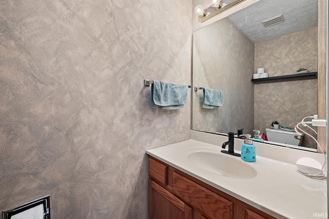 bathroom with vanity and a textured ceiling