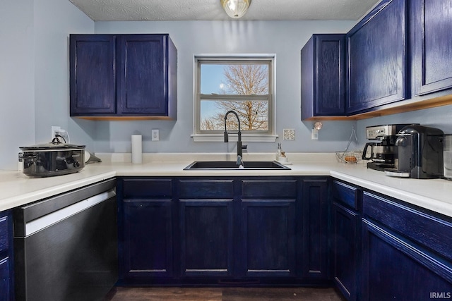 kitchen with blue cabinetry, sink, a textured ceiling, stainless steel dishwasher, and dark hardwood / wood-style flooring