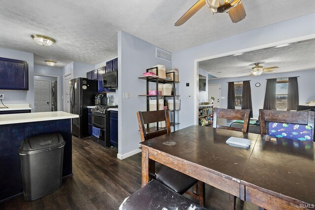 dining space with ceiling fan, dark wood-type flooring, and a textured ceiling