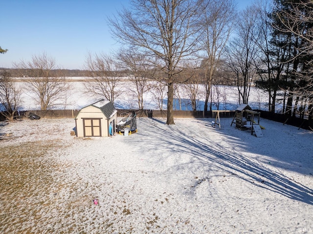 snowy yard with a storage unit