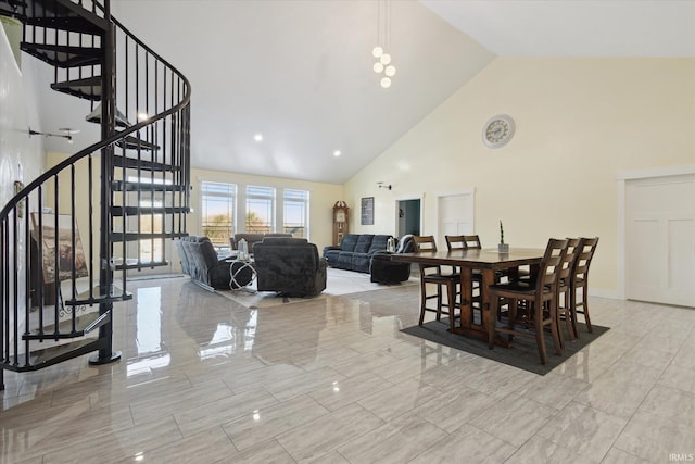 dining space with high vaulted ceiling