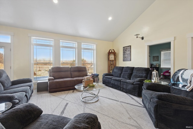 living room with high vaulted ceiling