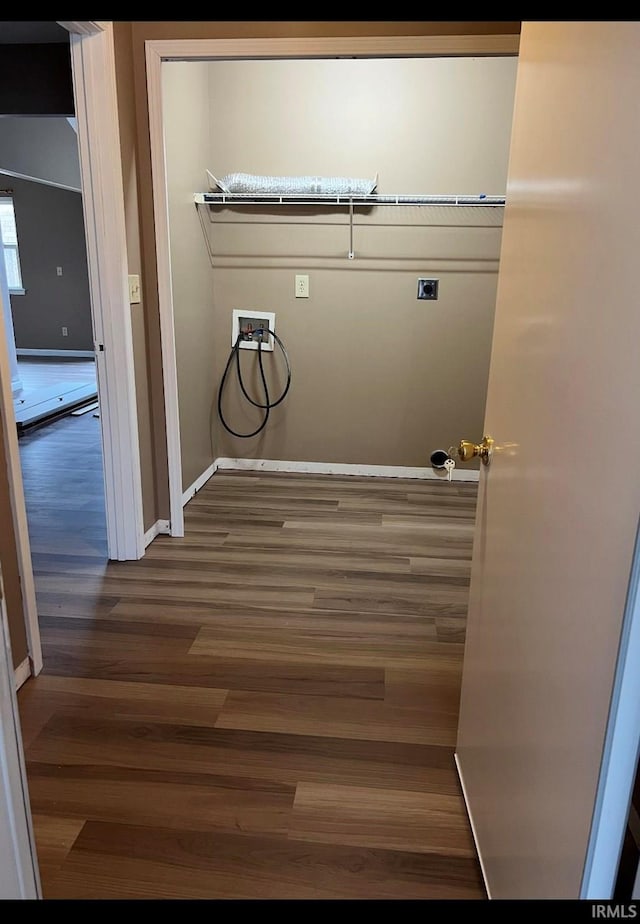 clothes washing area featuring dark hardwood / wood-style flooring, washer hookup, and electric dryer hookup