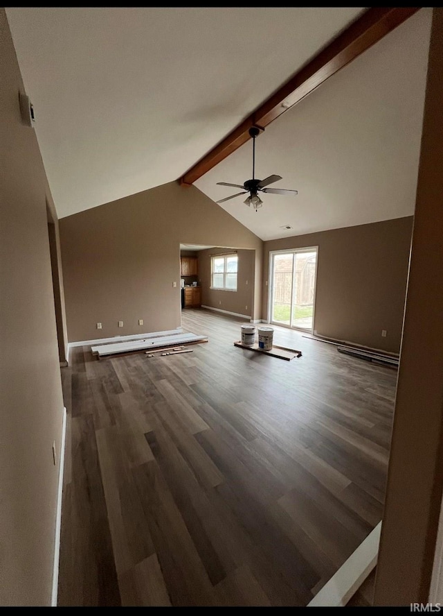 unfurnished living room featuring lofted ceiling with beams, dark hardwood / wood-style floors, and ceiling fan