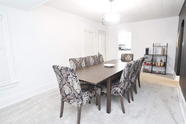 dining room featuring light carpet