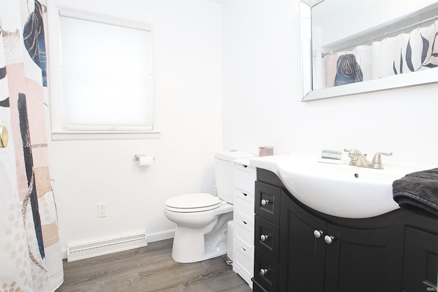 bathroom featuring vanity, a baseboard heating unit, hardwood / wood-style flooring, and toilet