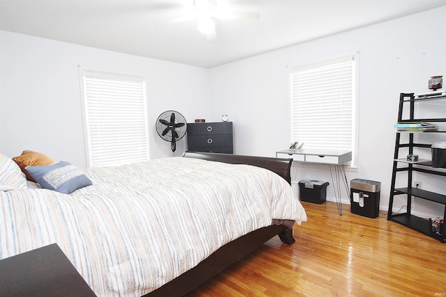 bedroom with wood-type flooring and ceiling fan