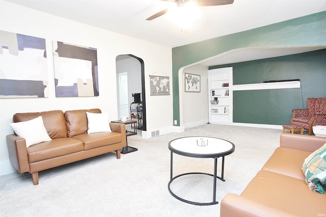 living room featuring ceiling fan, carpet floors, and built in features