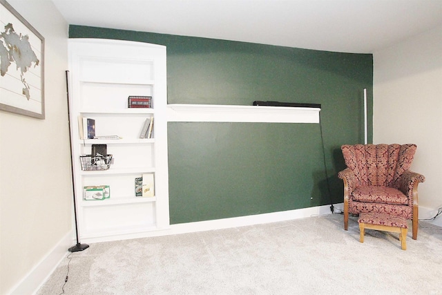 sitting room with carpet and built in features