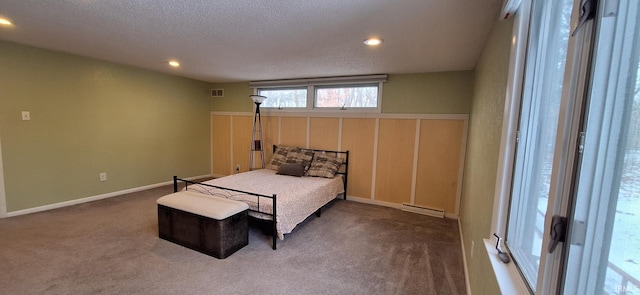 carpeted bedroom with a textured ceiling