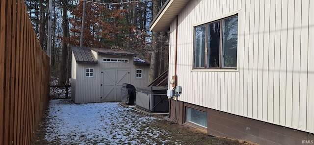 snow covered property featuring a storage unit