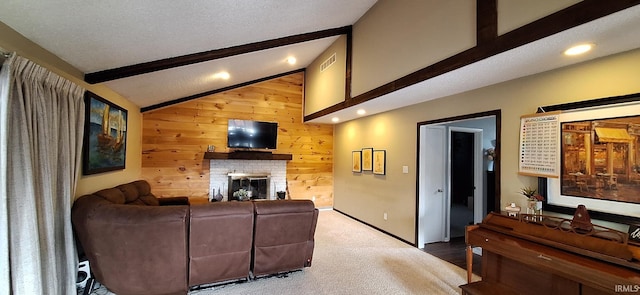 carpeted living room with a brick fireplace, vaulted ceiling with beams, a textured ceiling, and wooden walls