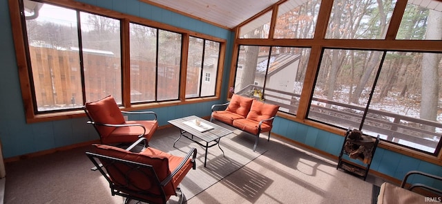 sunroom / solarium featuring lofted ceiling and plenty of natural light