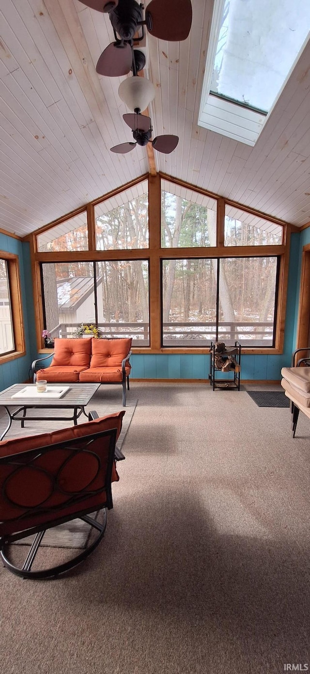 living room with carpet floors, vaulted ceiling, a healthy amount of sunlight, and ceiling fan