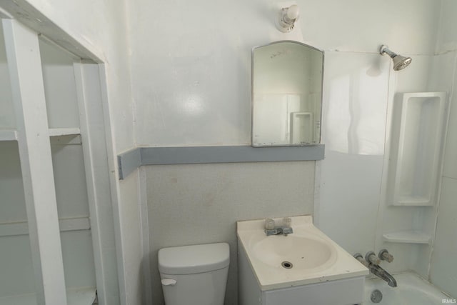 bathroom with vanity, toilet, and a washtub