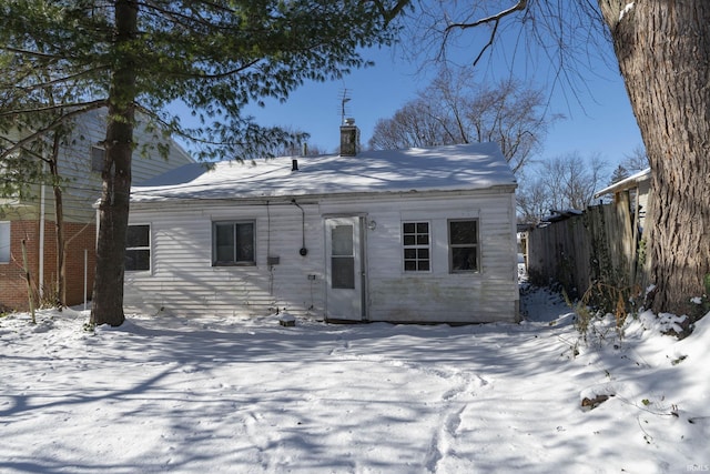 view of snow covered back of property