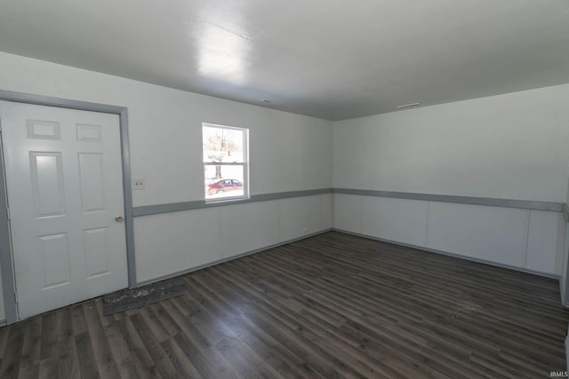 empty room featuring dark hardwood / wood-style flooring