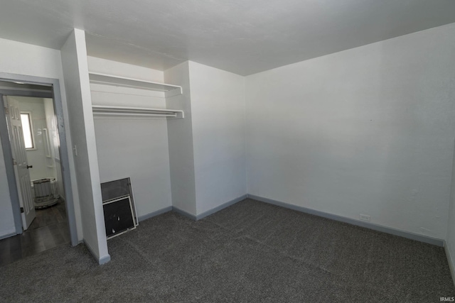 interior space with dark colored carpet