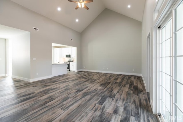 unfurnished living room with ceiling fan, dark wood-type flooring, and high vaulted ceiling