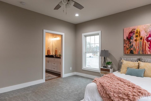 carpeted bedroom featuring ensuite bathroom and ceiling fan