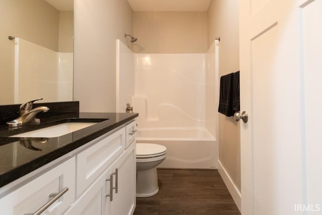 full bathroom featuring vanity, hardwood / wood-style flooring, shower / bathtub combination, and toilet