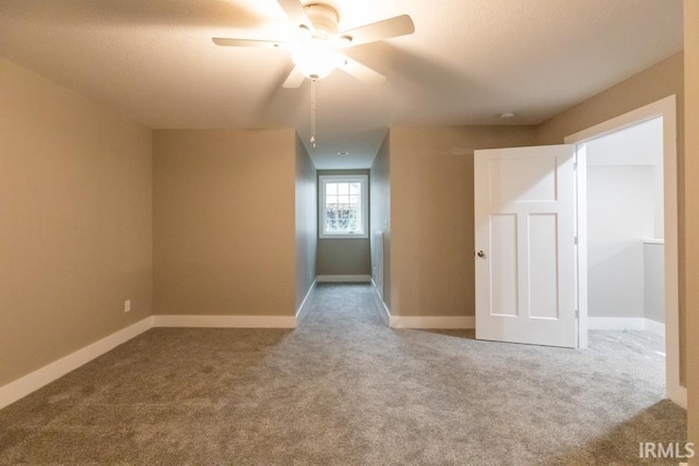 carpeted empty room featuring ceiling fan