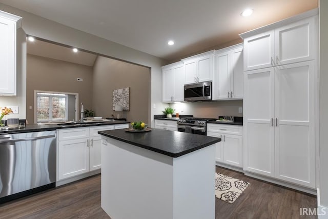 kitchen featuring white cabinetry, sink, dark wood-type flooring, and appliances with stainless steel finishes