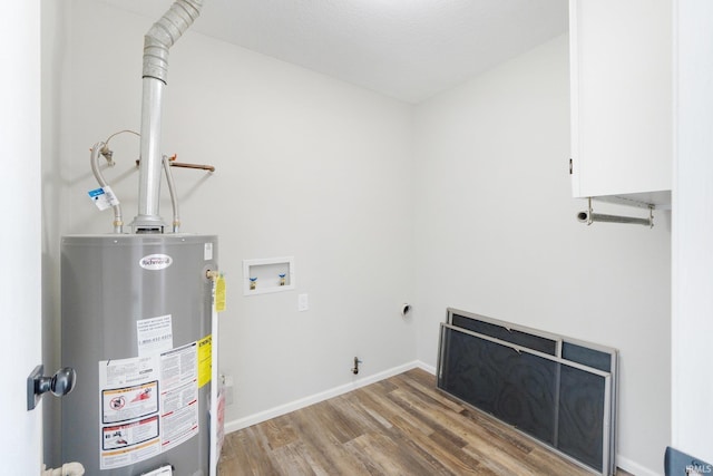 clothes washing area with washer hookup, hardwood / wood-style floors, and water heater