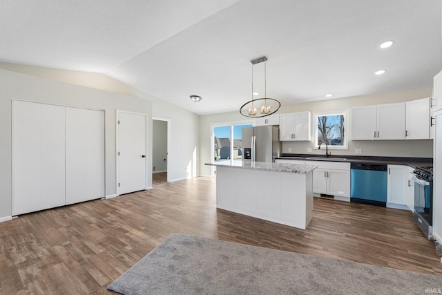 kitchen featuring hanging light fixtures, appliances with stainless steel finishes, a center island, and white cabinets