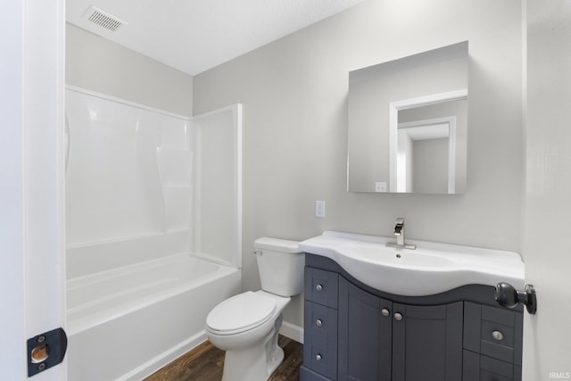 full bathroom with wood-type flooring, toilet, tub / shower combination, and vanity