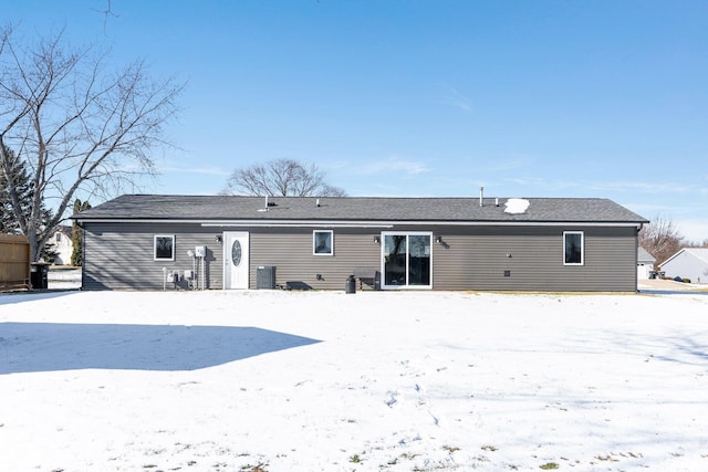 view of snow covered rear of property