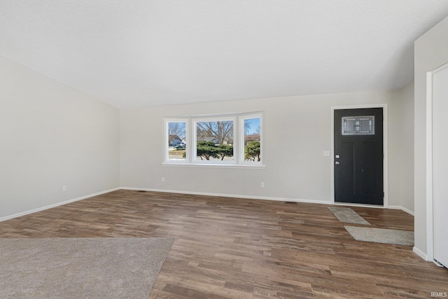 foyer entrance featuring dark wood-type flooring and a textured ceiling