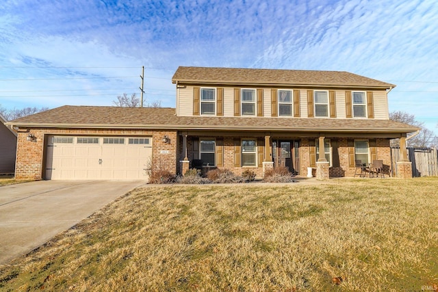 view of front of house featuring a porch, a garage, and a front yard