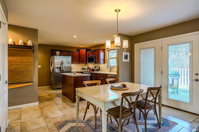 dining room featuring sink and a chandelier