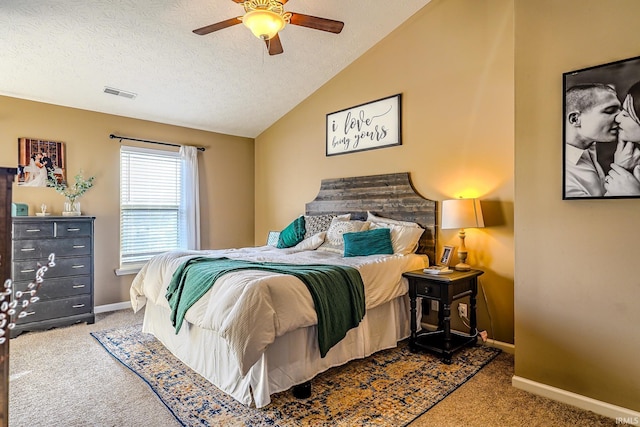 bedroom featuring a textured ceiling, vaulted ceiling, ceiling fan, and carpet flooring