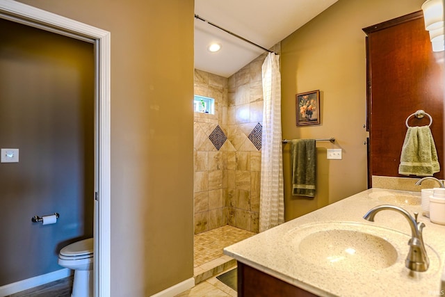 bathroom featuring tile patterned flooring, toilet, vanity, and a shower with curtain