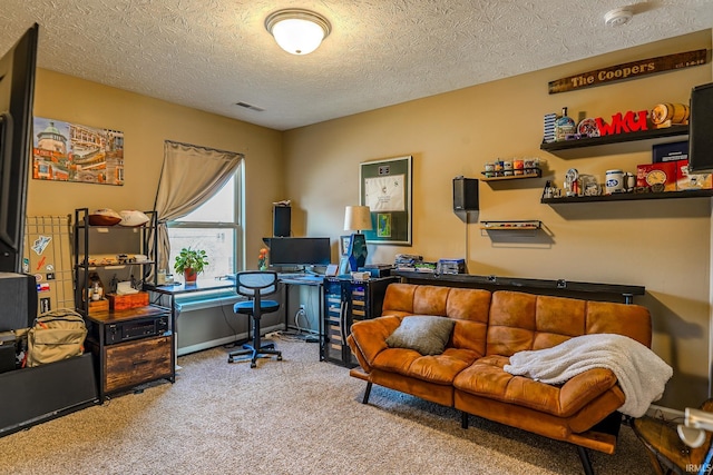 home office featuring light carpet and a textured ceiling