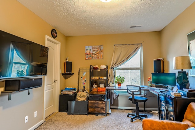 office space featuring carpet flooring and a textured ceiling