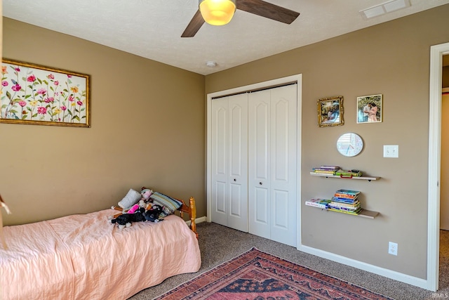 bedroom with ceiling fan, carpet flooring, and a closet